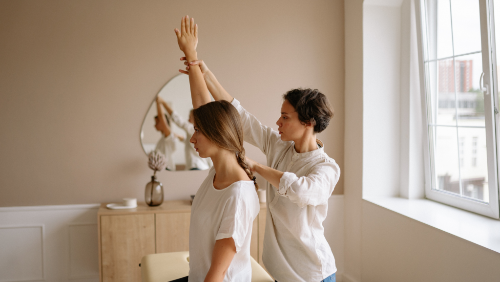 A chiropractor giving a home visit to a Nine Elms Chiropractic patient