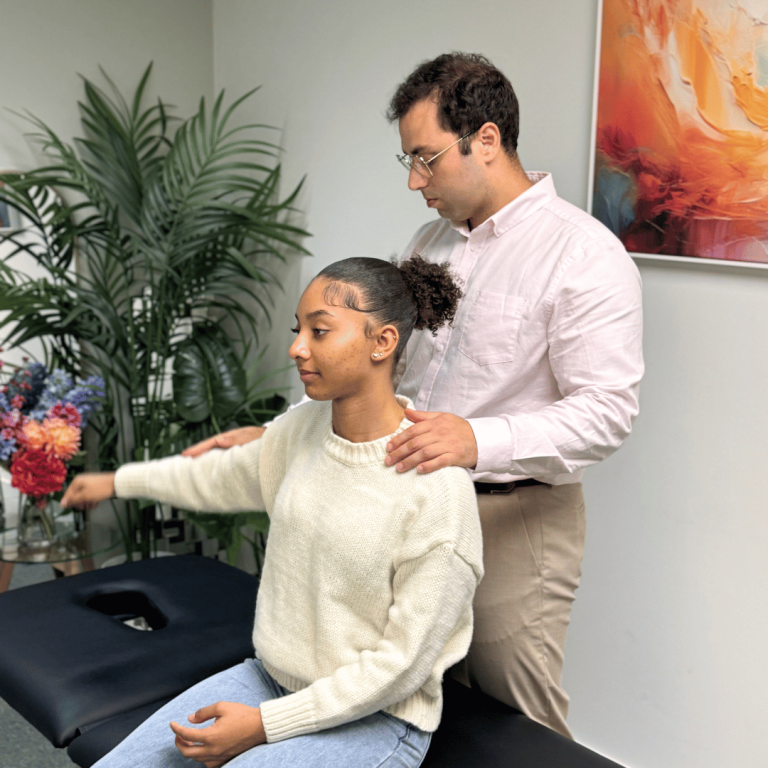Physio Vauxhall clinician guiding a patient through a shoulder mobility exercise